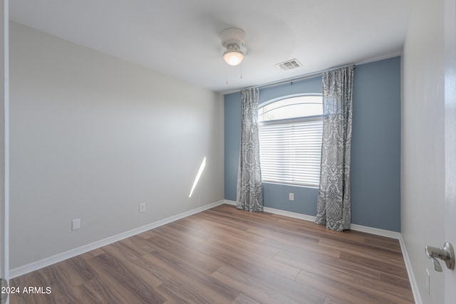 spare room featuring ceiling fan and hardwood / wood-style floors