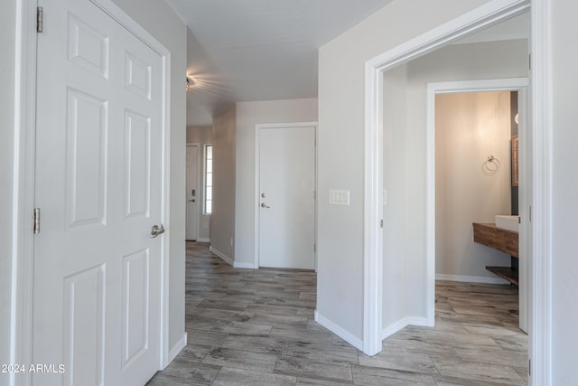 hallway with light hardwood / wood-style flooring