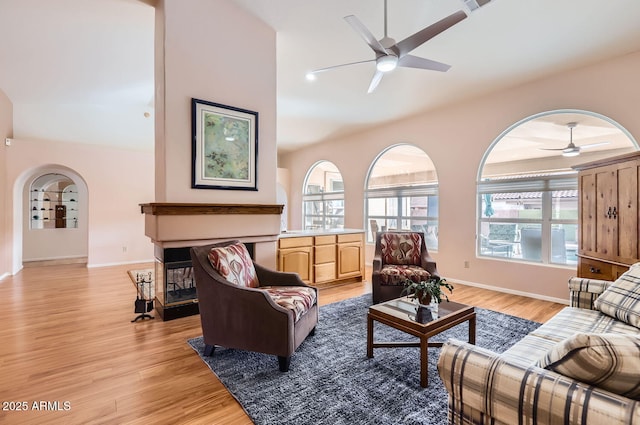 living room with light hardwood / wood-style floors and ceiling fan