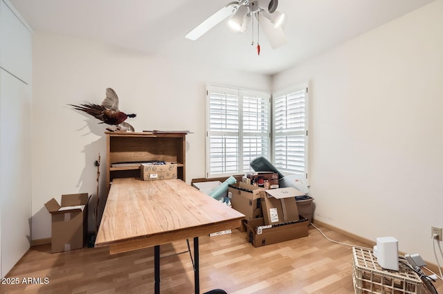 home office featuring hardwood / wood-style floors and ceiling fan