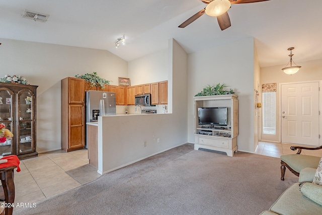 interior space with kitchen peninsula, appliances with stainless steel finishes, light colored carpet, ceiling fan, and pendant lighting