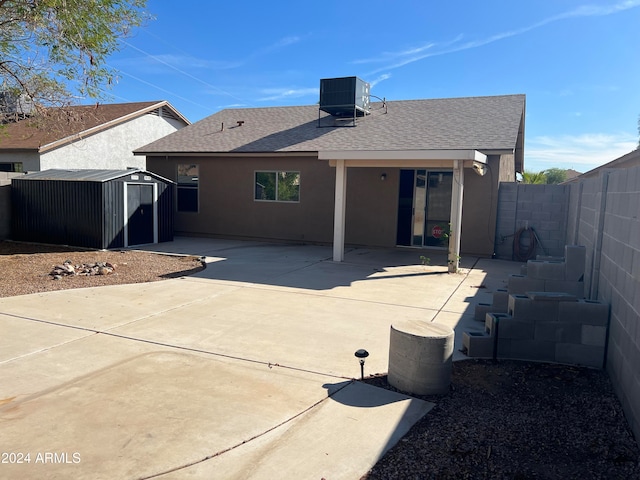 back of property with a patio, a storage unit, and central air condition unit