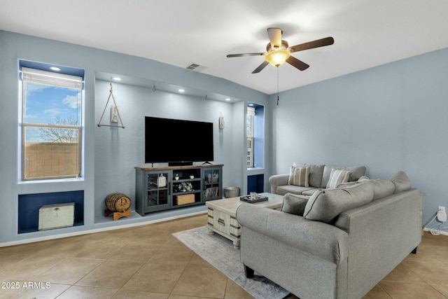 tiled living room with ceiling fan and a healthy amount of sunlight
