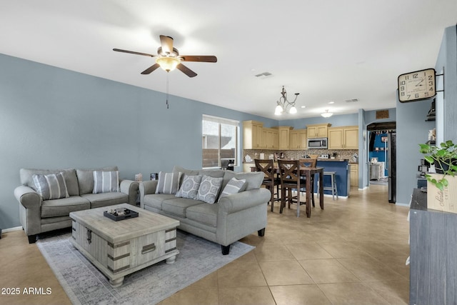 tiled living room featuring ceiling fan