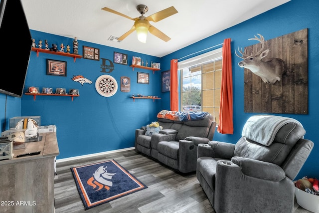 interior space with dark wood-type flooring and ceiling fan