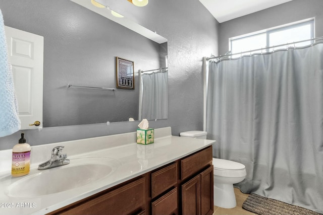 bathroom featuring tile patterned floors, vanity, and toilet