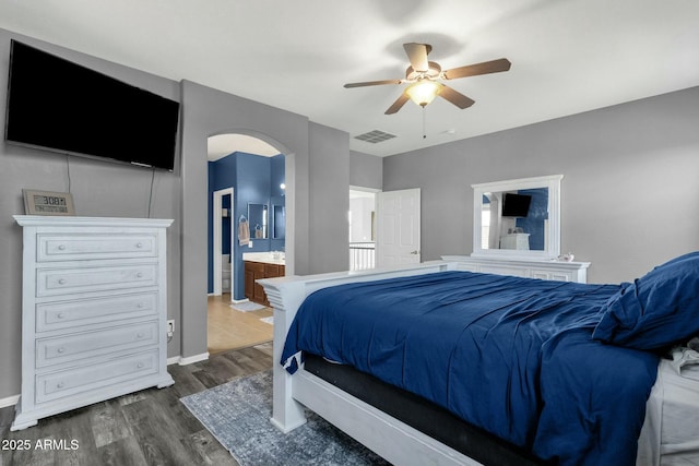 bedroom with dark hardwood / wood-style flooring, ceiling fan, and ensuite bathroom