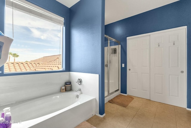 bathroom with tile patterned floors, plus walk in shower, and a healthy amount of sunlight