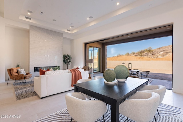 dining room featuring a wealth of natural light and a tray ceiling