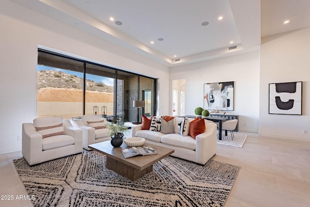 living room featuring a raised ceiling