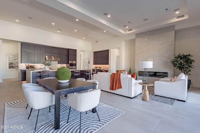 living room featuring a fireplace and a high ceiling