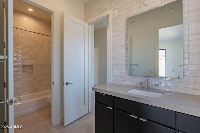 full bathroom featuring vanity, toilet, tile patterned floors, and decorative backsplash