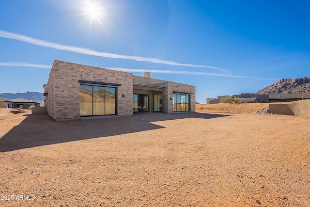 back of house featuring a mountain view