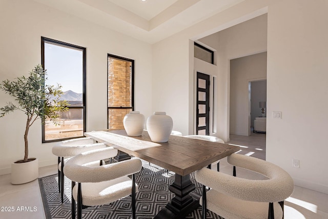 dining space featuring a towering ceiling