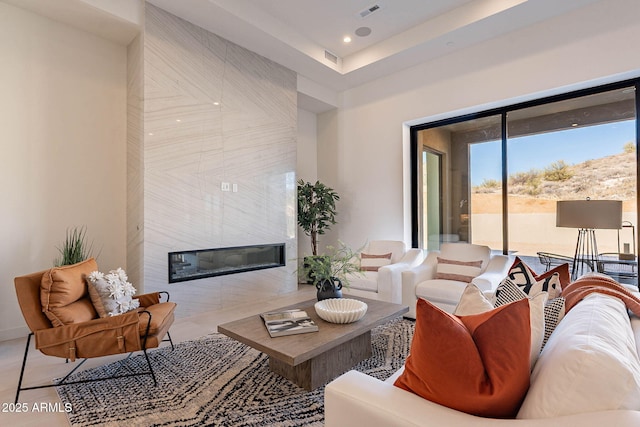 living room featuring a tiled fireplace