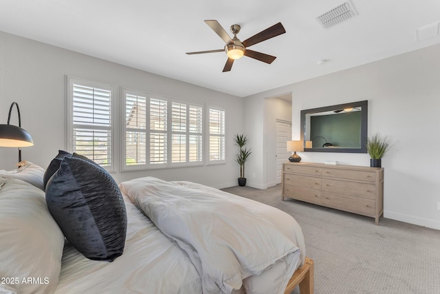 bedroom featuring baseboards, ceiling fan, visible vents, and light colored carpet