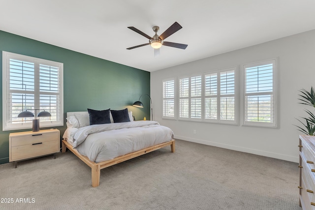 carpeted bedroom featuring ceiling fan and baseboards