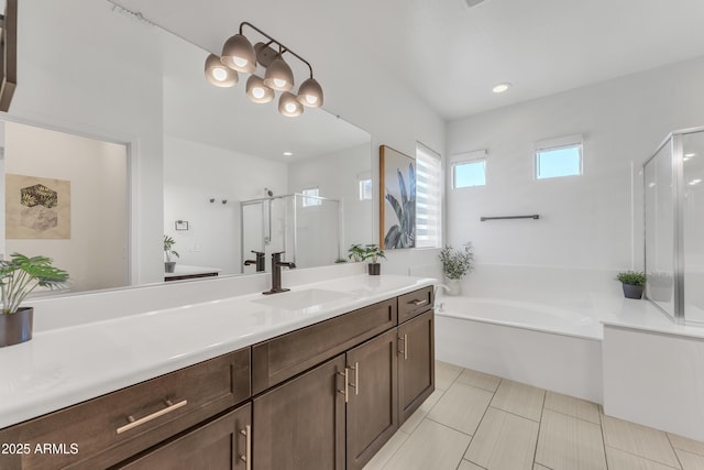 bathroom with an inviting chandelier, a stall shower, vanity, a bath, and tile patterned floors