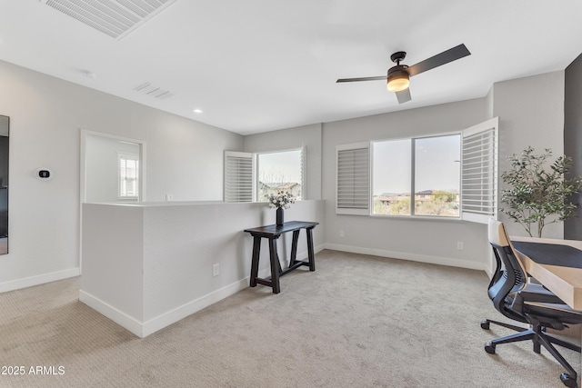 office with carpet flooring, visible vents, and baseboards