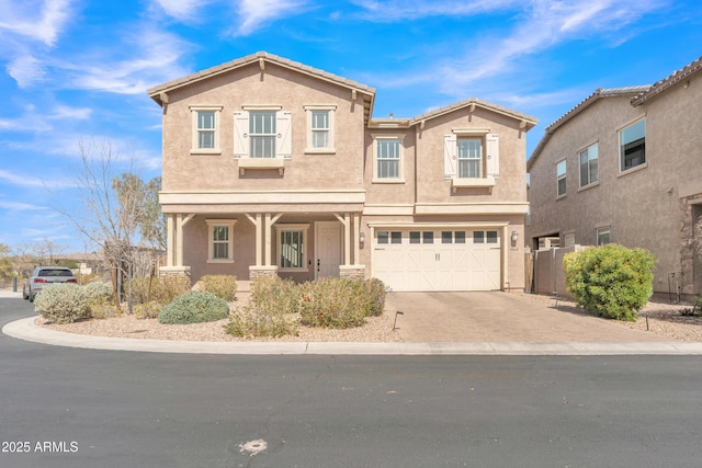 view of front facade with driveway, a garage, and stucco siding