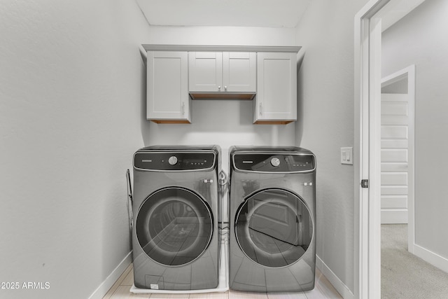 clothes washing area featuring carpet floors, cabinet space, independent washer and dryer, and baseboards