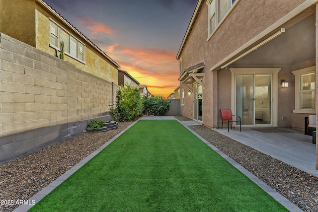 view of yard with a patio area and a fenced backyard