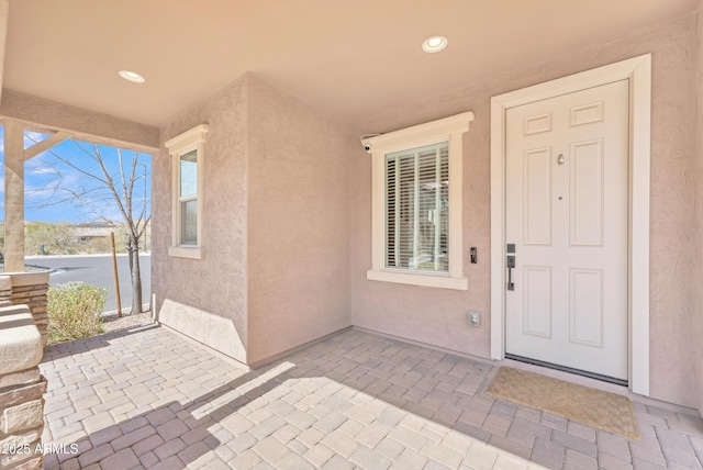 doorway to property with a patio and stucco siding