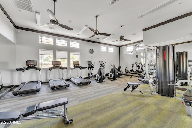 gym with carpet, visible vents, and crown molding