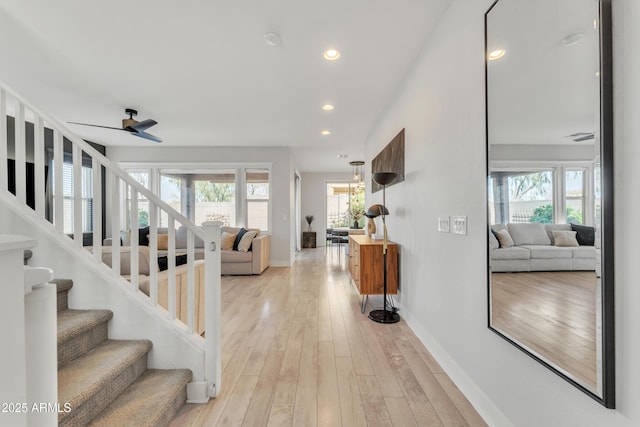 interior space with a healthy amount of sunlight, baseboards, hardwood / wood-style floors, and recessed lighting