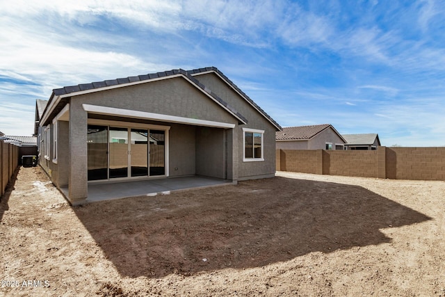 rear view of house with a patio and central AC unit