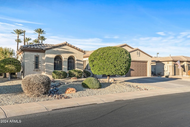 mediterranean / spanish-style home with a garage