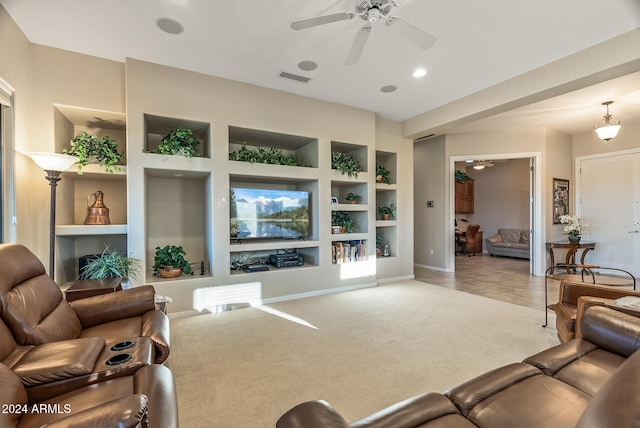 living room featuring carpet flooring, ceiling fan, and built in features