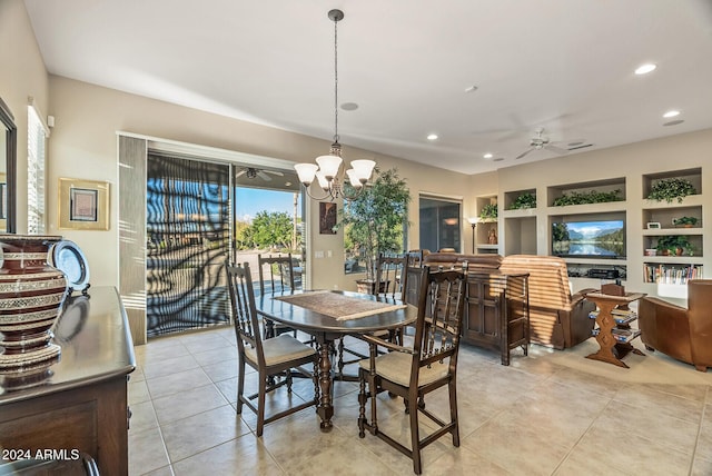 tiled dining space with ceiling fan with notable chandelier and built in features