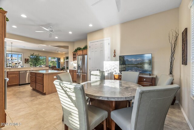 tiled dining room with ceiling fan