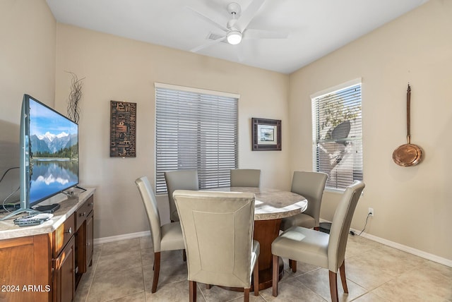 dining space with ceiling fan and light tile patterned floors