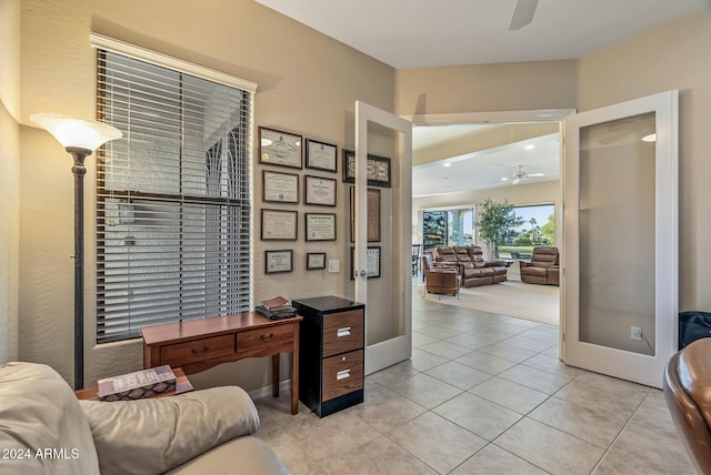 tiled home office featuring ceiling fan and french doors