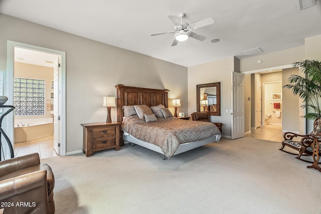 bedroom with ensuite bathroom, ceiling fan, and light colored carpet