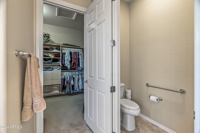 bathroom featuring tile patterned flooring and toilet