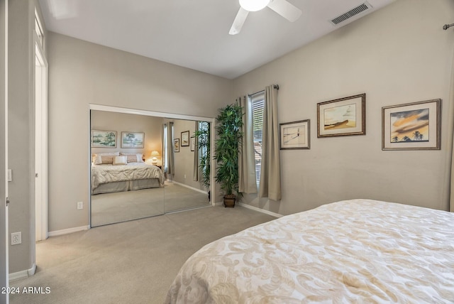 carpeted bedroom featuring ceiling fan and a closet