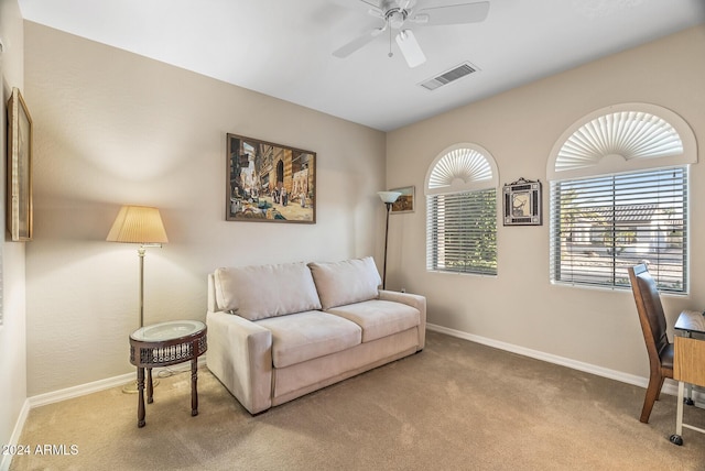 living room featuring carpet floors and ceiling fan