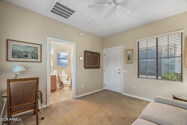 carpeted living room with ceiling fan