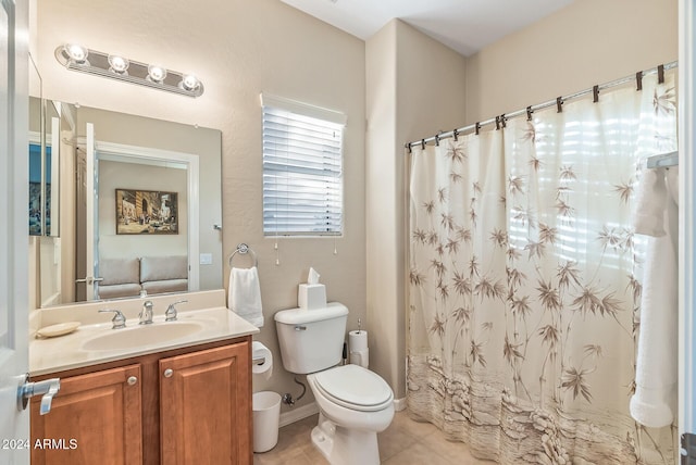 bathroom with tile patterned flooring, vanity, and toilet