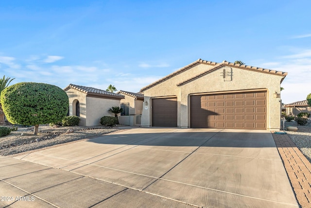 mediterranean / spanish-style home featuring a garage