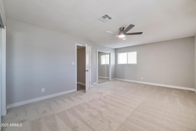 unfurnished bedroom featuring ceiling fan and light carpet