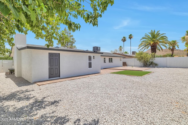 back of property featuring a patio and central AC