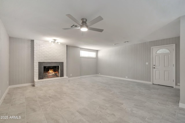 unfurnished living room featuring a fireplace and ceiling fan