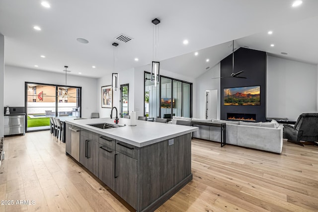 7851 N Central Ave, Phoenix, AZ 85020 - kitchen featuring a sink, a center island with sink, light countertops, modern cabinets, and light wood-style floors