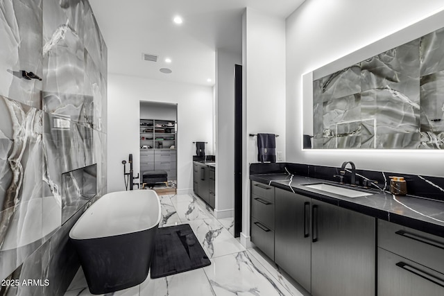 7851 N Central Ave, Phoenix, AZ 85020 - full bath featuring marble finish flooring, vanity, a freestanding tub, a walk in closet, and recessed lighting