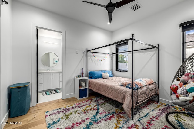 7851 N Central Ave, Phoenix, AZ 85020 - bedroom featuring wood finished floors, connected bathroom, baseboards, and ceiling fan