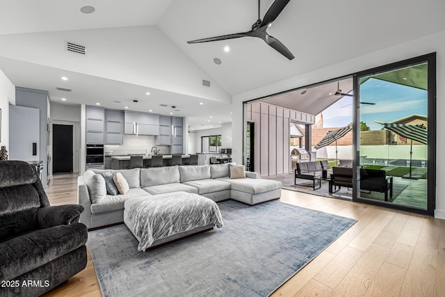 7851 N Central Ave, Phoenix, AZ 85020 - living room featuring a ceiling fan, light wood-type flooring, high vaulted ceiling, and recessed lighting